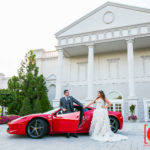 bride and groom posing infront the palace at somerset park wedding with red ferrari 458